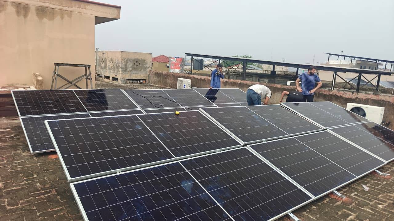Sun Box ESS technicians installing solar panels on a rooftop